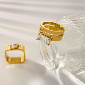 Detailed close-up of 18K gold plated rings with teardrop and square zircon stones