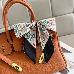 Brown litchi leather handbag with gold lock and floral silk scarf wrapped handle