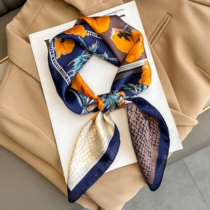 Floral print silk scarf with geometric patterns on a blazer for a stylish autumn look