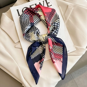 Fashion houndstooth geometric silk scarf with red and navy color-blocking on a beige blazer