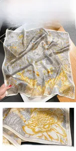 Detailed view of silk scarf with botanical prints and precision stitched edging