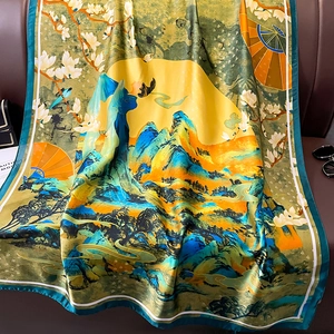Elegant Chinese landscape print silk scarf draped on a brown leather sofa for vacation