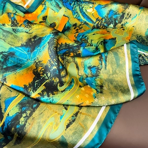 Detail of silk scarf showing traditional Chinese landscape print and satin texture