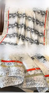 Detail of silk scarf featuring snake print, red borders and golden chain patterns