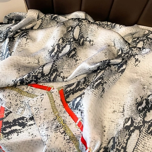 Fashionable faux silk long scarf with snake print and chain pattern over leather texture
