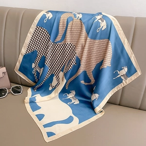 Elegant Klein blue silk scarf featuring horse patterns on a premium leather background