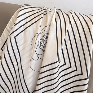 Fashionable camellia silk scarf with black diagonal borders on a soft white chiffon fabric