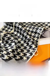 Close-up of classic houndstooth silk scarf with premium satin sheen and fine inner stitching