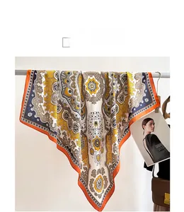 Detail of vintage palace pattern silk scarf with orange borders draped on a rack