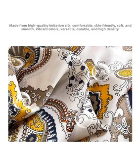 Close-up of soft paisley silk-like scarf texture showing drape and orange pattern