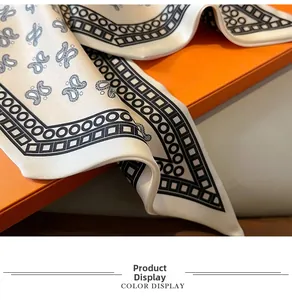 Macro shot of paisley silk scarf with glossy texture on a vibrant orange box