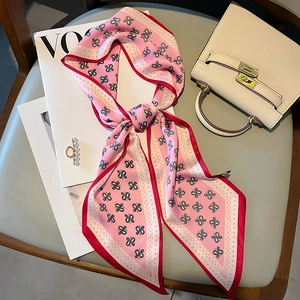 Pink paisley print narrow silk scarf styled with a luxury bag and magazine for fashion