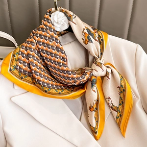 Fashionable silk scarf with equestrian horse print in orange and beige on white blazer