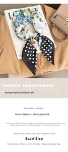 Close-up of elegant floral polka dot silk scarf draped over a khaki blazer