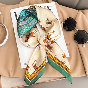 Silk-like scarf with vintage horse print and blue wavy border on khaki blazer