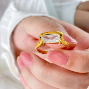Gold plated 18K ring featuring a large emerald cut rectangular clear zircon stone