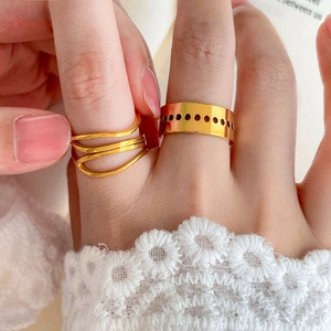 Detailed macro view of 18K gold plated multi-layer wire and hollow perforated ring set