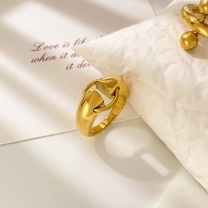 Macro shot of 18K gold plated steel ring with abstract double ball and star design