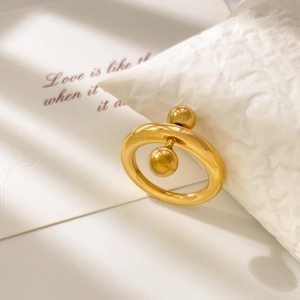 Detail of 18K gold plated titanium ring with unique double ball and geometric snail design