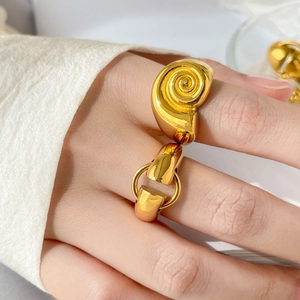 Polished 18K gold plated snail and horsebit wrap ring on a model's finger