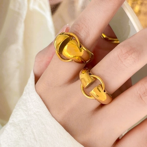 Detailed close-up of 18K gold plated horsebit style rings showing polished mirror finish