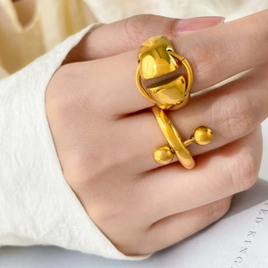 Polished 18K gold plated titanium ring featuring geometric ball and disc details