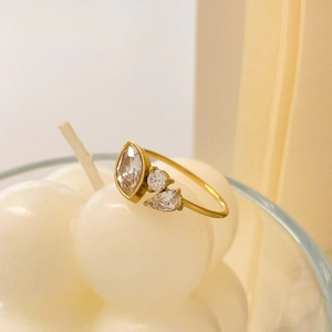 Macro shot of 18K gold plated ring featuring marquise and round cut zircon stones