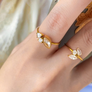 Detail shot of 18K gold plated titanium rings with marquise and teardrop zircon accents