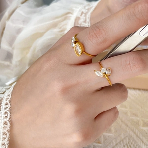 Macro shot of 18K gold plated stackable rings with marquise zircon stones and leaf patterns