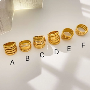 Detailed top view of six varied 18K gold plated multi-layer wrap rings labeled A to F