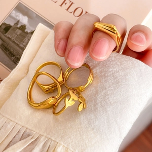 Set of four 18K gold-plated minimalist rings featuring wide square and curved leaf designs