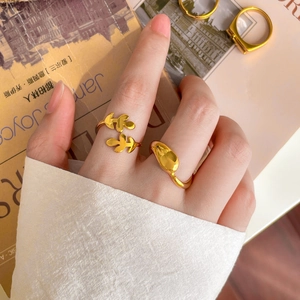 Close-up of a 18K gold plated hollow leaf ring and water drop ring on a model hand