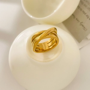 Macro detail of multi-layer crisscross gold ring showcasing its 18K plated texture