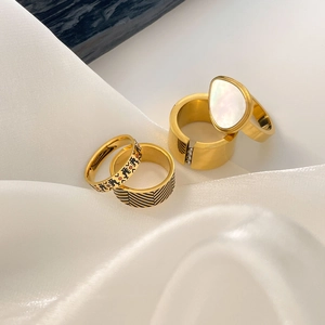 Set of four 18K gold plated titanium steel rings with shell inlay and black enamel patterns
