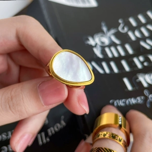 Macro shot of 18K gold plated ring featuring a teardrop shell inlay and polished thick band