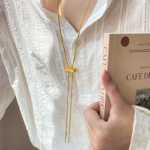 Minimalist 18K gold-plated snake chain necklace with teardrop slider on white shirt
