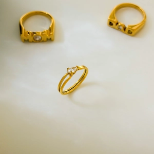 Detail of 18K gold plated ring featuring a pear-shaped zircon on a sleek double band