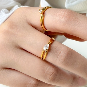 Macro detail of 18K gold plated double band rings with sparkling zircon accents