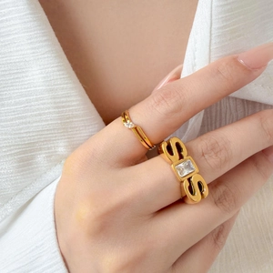 Detail of 18K gold plated zircon rings with geometric design on model hand