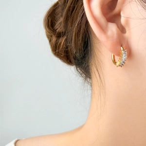 Detail of 18K gold plated hoop earrings with five rectangular cut sparkling zircons