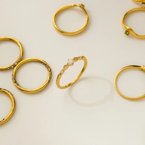 Detail of 18K gold plated stackable rings with white, purple and green zircon crystals