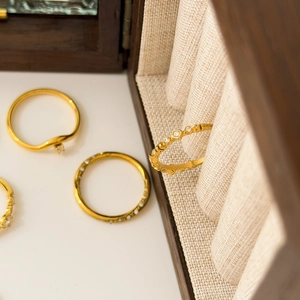 Close-up of minimalist 18K gold plated stackable rings with delicate micro diamonds