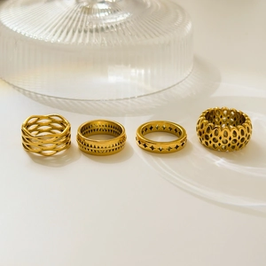 Set of four 18K gold plated stainless steel rings featuring geometric cutouts and wavy patterns