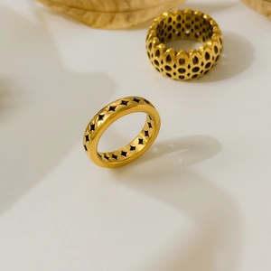 Close-up of 18K gold-plated rings featuring honeycomb cutout and star patterns