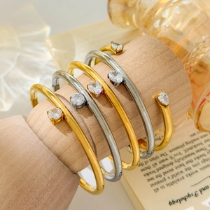 Minimalist 18K gold and silver plated bangles with pear and round cubic zirconia stones