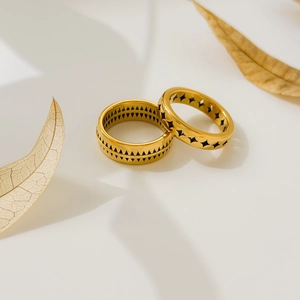 Detailed view of geometric pattern gold plated rings with bohemian triangle and star motifs