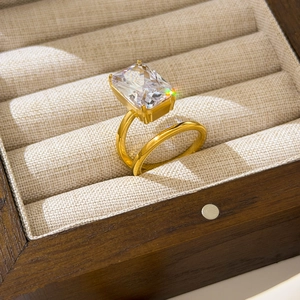 Detailed view of emerald cut rectangular zircon ring on 18K gold double layer band