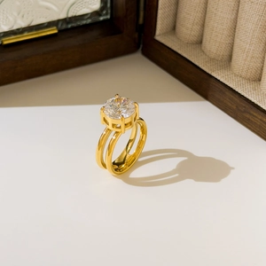 Detail of 18K gold plated double band ring with large round zircon in four-prong setting
