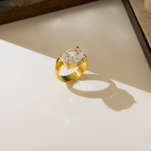 Macro shot of large oval-cut cubic zirconia in 18K gold-plated titanium steel ring