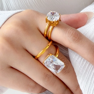 Close-up of 18K gold plated double ring set with round and emerald cut cubic zirconia